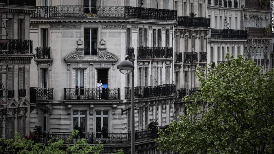 A woman applauds from the balcony of her Paris home to show support for health care workers on April 20.